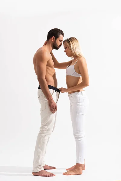 Seitenansicht des schönen leidenschaftlichen Paares, das sich auf Weiß umarmt — Stockfoto