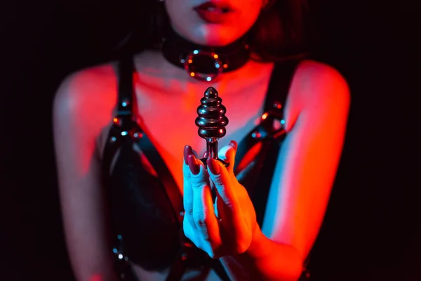Metal butt plug in the hands of a slave girl with a choker — 스톡 사진